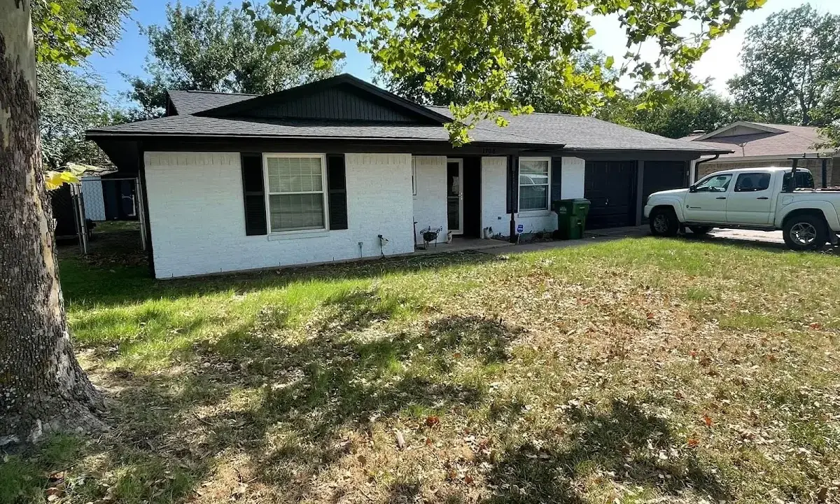 Professional roofing crew working on a residential roof in Millington